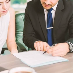 A lawyer explaining paperwork to a client