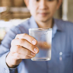 A person holding contaminated drinking water