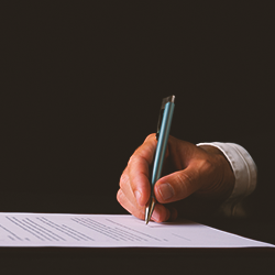 A person signing a paper