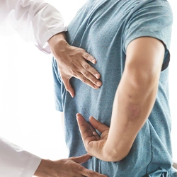 A doctor checking a patient's spine 