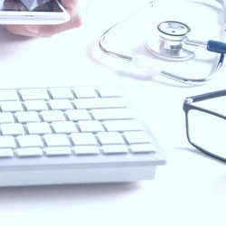 A keyboard next to a stethoscope 