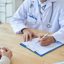 A medical professional in the middle of examinations