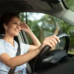 A person using a headphone while driving.