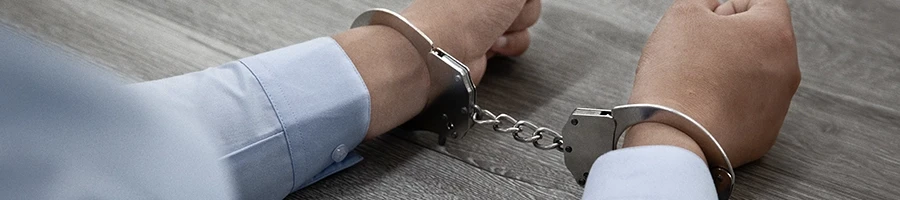 A close up shot of a man on a handcuffs