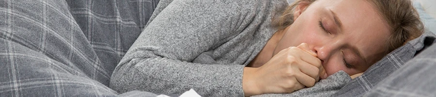 A woman on the bed who has a fever