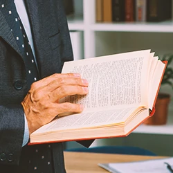 A lawyer holding a law book