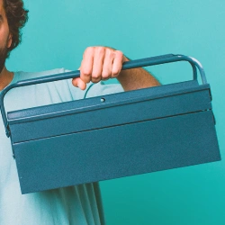 A person holding a toolbox