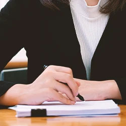 A business person writing down on paperwork