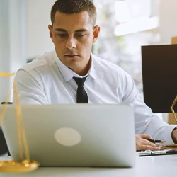 A lawyer being notified via email on a laptop