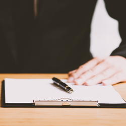 A lawyer with a pen and a clipboard