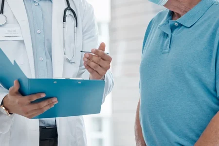 A doctor discussing the signs and symptoms of a defective hernia mesh