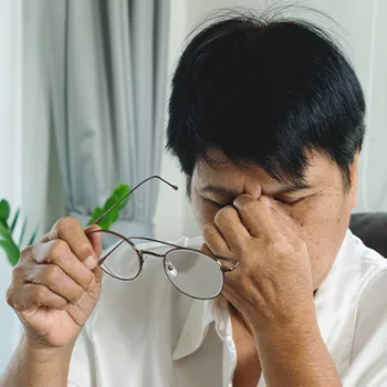 Old woman holding her nose out of discomfort