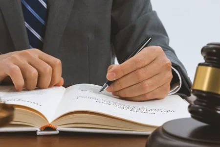 A lawyer reading the types of warrants in a law book