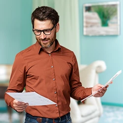A man reading papers at home