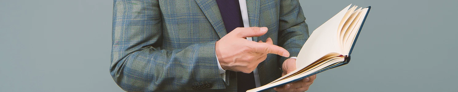 A lawyer pointing to a law book that explains the elements of a criminal threat