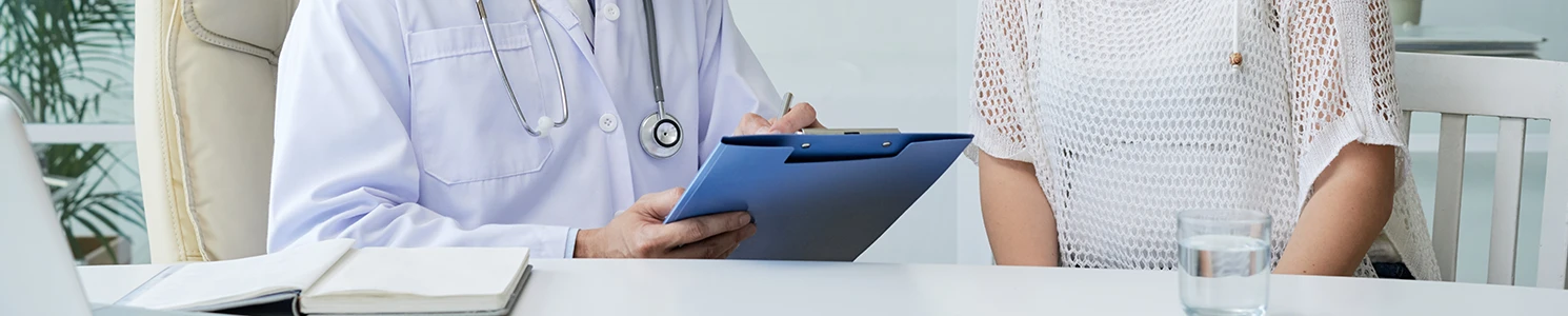 A patient listening to a doctor discussing the symptoms of perforation of blood vessels