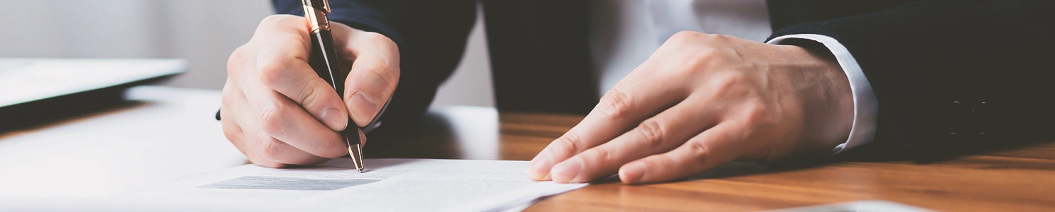 A person signing papers
