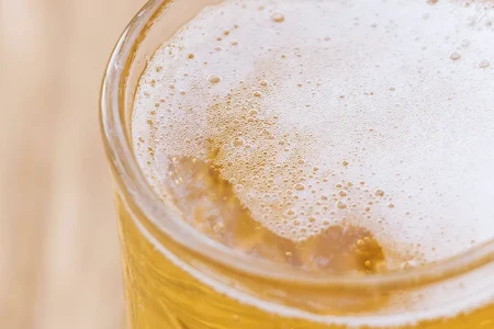 Close up shot of foamy beer in a glass