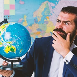 A lawyer looking at a globe