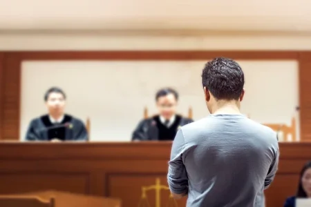 A man attending an arraignment hearing for a felony