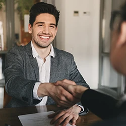 An applicant shaking hands with the employer