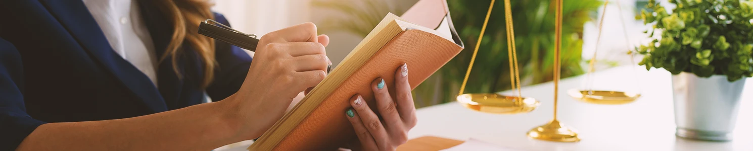 A lawyer writing down notes on a book