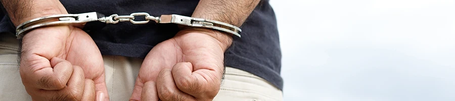 A close up shot of a man in handcuffs