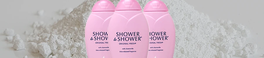 Three pieces of Shower-To-Shower baby powder and talcum powder in the background