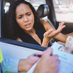 A woman and an enforcer talking about car accident settlements