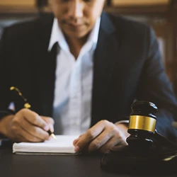 A lawyer writing down the burden of proof for a glyphosate claim