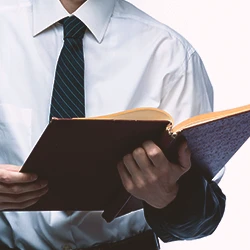 A lawyer holding a book while reading the collateral source rule
