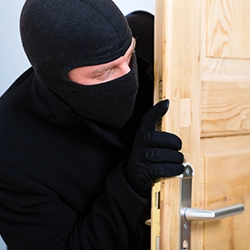 A burglar sneaking into someone's house