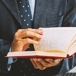 A lawyer looking at the first amendment in a law book