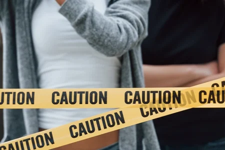 a picture of people and a caution sign