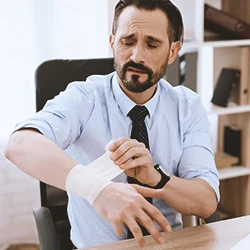 A person taking care of his carpal tunnel in an office