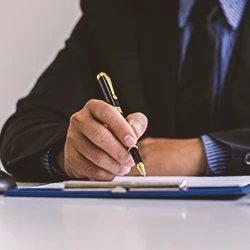 A lawyer writing down on a clipboard