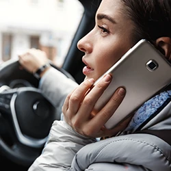 A woman having a call while driving