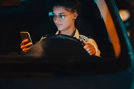 A woman using a phone while driving