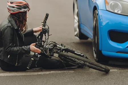 A woman riding a bike who had an accident with a car