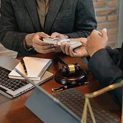 An image of two people handing over money
