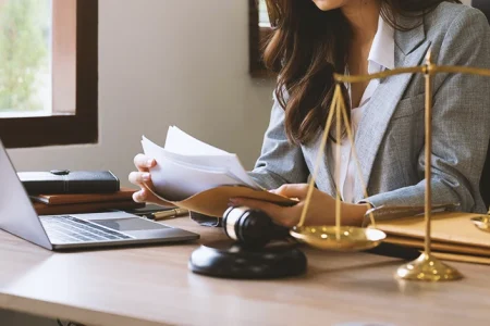A woman handling documents on legal standing