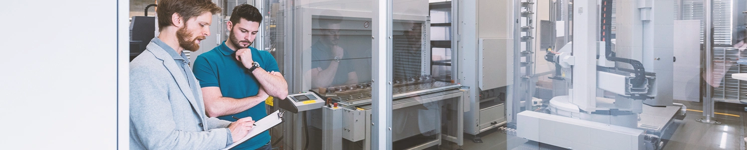 Two persons discussing between each other at a factory