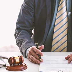 A lawyer signing paperwork