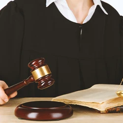 A judge reading a verdict for a preliminary hearing