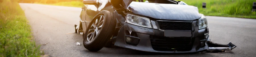 A shattered car in the middle of the road