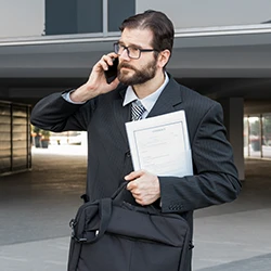 A lawyer standing while having a phone call