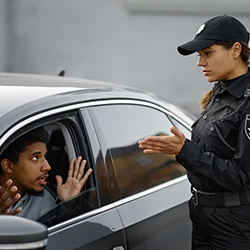 An image of a police cop talking to a car driver