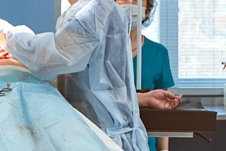 surgeons continuing surgery to help patient