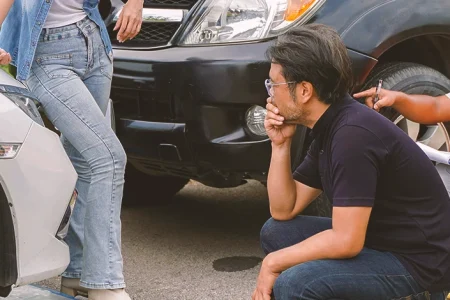 People in a car accident discussing outside of the cars