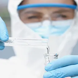 chemicals in a vial held by a lab person